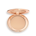 An open, pressed powder compact in a light beige shade.